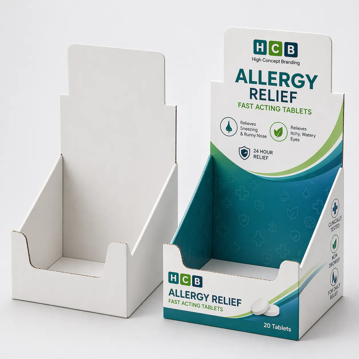 A blank white medicine box standing beside a blue floral branded box for allergy tablets. class=